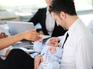 Business people taking care of baby in office